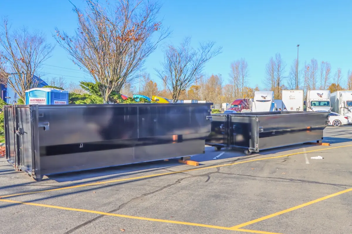 Professional dumpster rental service with roll-off container on residential driveway in Valdosta